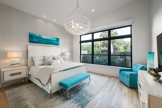 6420 Azalea Ln, Dallas, TX 75230 - bedroom with a chandelier, light wood-type flooring, recessed lighting, high vaulted ceiling, and an accent wall