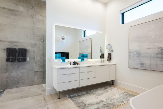 6420 Azalea Ln, Dallas, TX 75230 - bathroom with double vanity, a shower stall, a high ceiling, a fireplace, and baseboards
