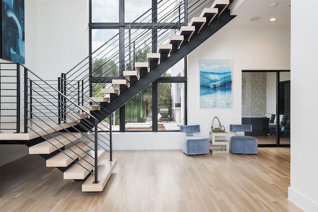 6420 Azalea Ln, Dallas, TX 75230 - staircase featuring wood finished floors, baseboards, and a high ceiling