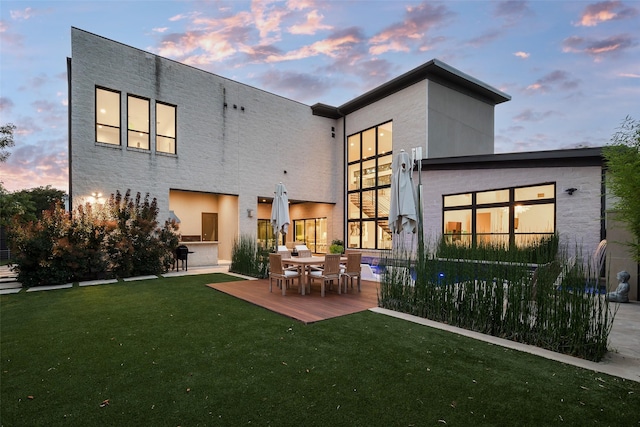 6420 Azalea Ln, Dallas, TX 75230 - back of property at dusk with a lawn