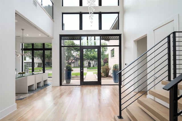 6420 Azalea Ln, Dallas, TX 75230 - foyer with a chandelier, a towering ceiling, stairs, and wood finished floors