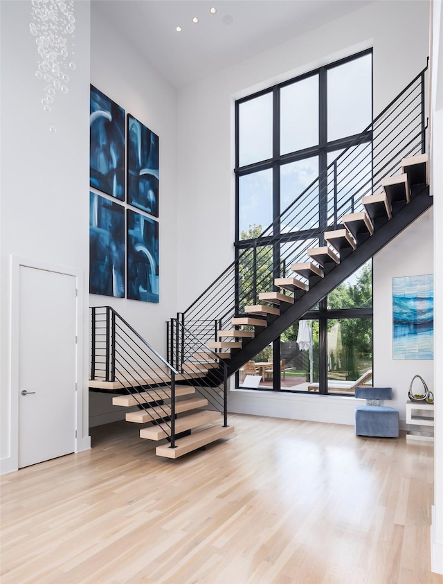 6420 Azalea Ln, Dallas, TX 75230 - stairway featuring a high ceiling, wood finished floors, and recessed lighting