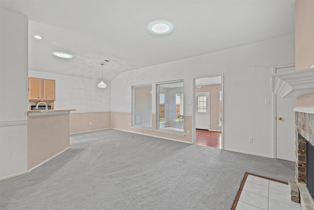 1100 Cedarcrest Dr, Mesquite, TX 75149 - unfurnished living room featuring a fireplace, light colored carpet, and baseboards