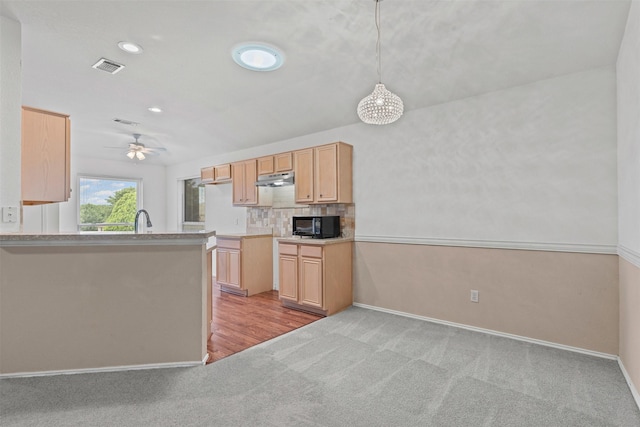 1100 Cedarcrest Dr, Mesquite, TX 75149 - kitchen featuring light colored carpet, black microwave, under cabinet range hood, light brown cabinets, and recessed lighting