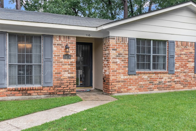 9804 W Trails End, Shreveport, LA 71118 - property entrance featuring brick siding and a yard