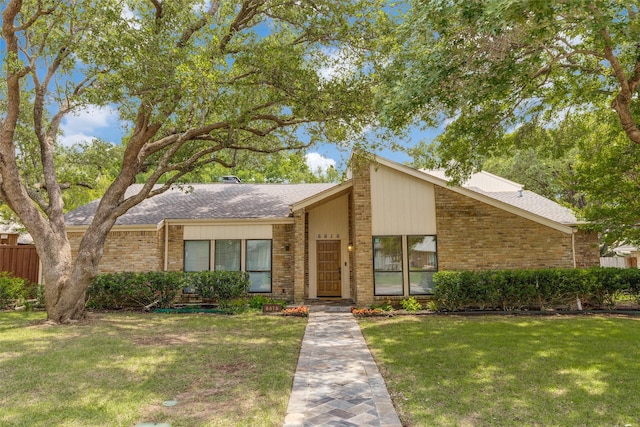 6616 Elvedon Dr, Dallas, TX 75248 - mid-century modern home featuring brick siding, a front yard, and a shingled roof