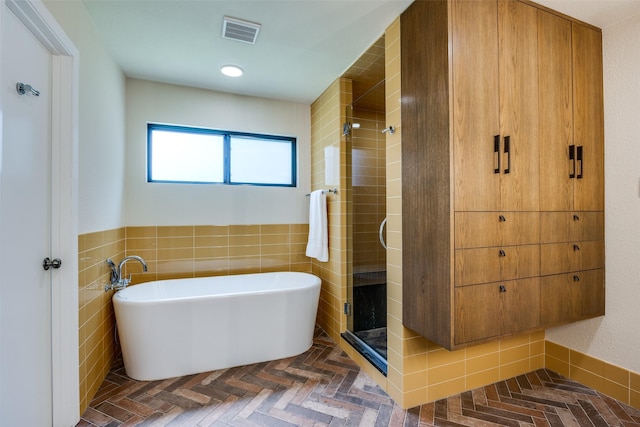 6616 Elvedon Dr, Dallas, TX 75248 - full bath featuring tile walls, a freestanding bath, a shower stall, and a wainscoted wall