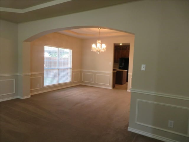 1501 Mountain Laurel Ln, Desoto, TX 75115 - carpeted spare room with arched walkways, a decorative wall, a chandelier, and a wainscoted wall
