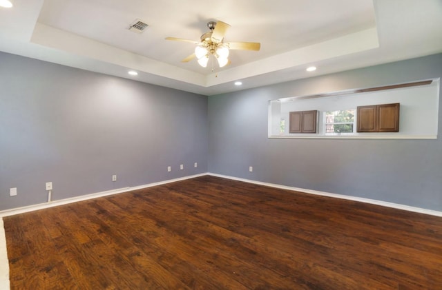 6650 Pine Mill Rd, Reno, TX 75462 - spare room with a raised ceiling, a ceiling fan, baseboards, recessed lighting, and dark wood-style floors