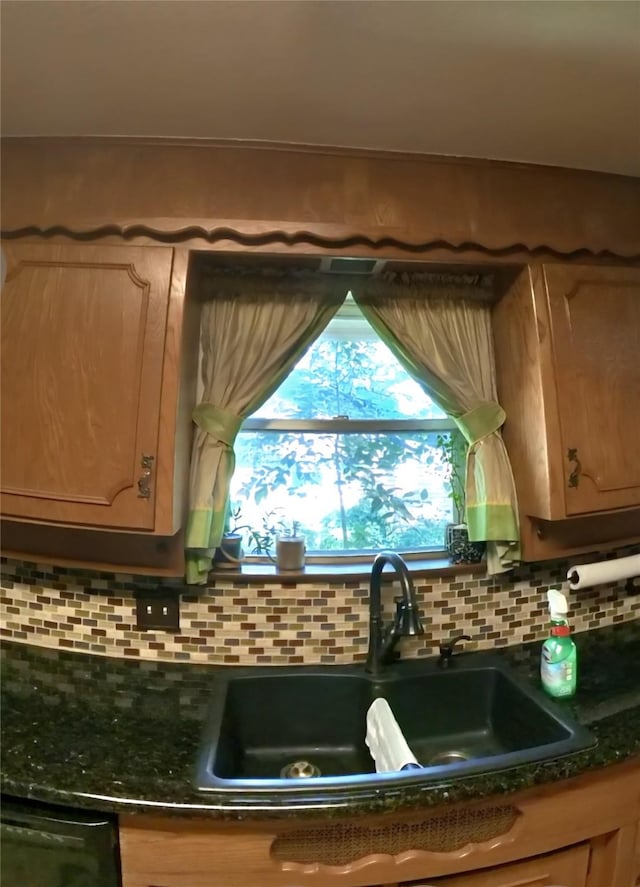 5805 Azteca Dr, Fort Worth, TX 76112 - kitchen featuring a sink, dark countertops, backsplash, and healthy amount of natural light