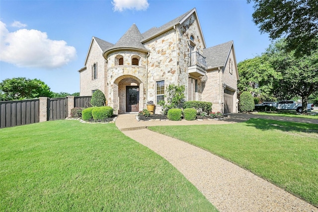 49 Pristine Pond Dr, Frisco, TX 75034 - french country inspired facade with stone siding, a balcony, an attached garage, driveway, and brick siding