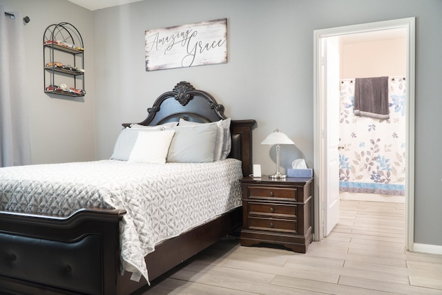 1204 Bluff View Dr, Hutchins, TX 75141 - bedroom featuring wood finished floors, baseboards, and connected bathroom