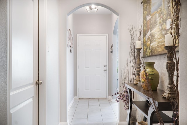 1204 Bluff View Dr, Hutchins, TX 75141 - doorway featuring arched walkways, light tile patterned floors, and baseboards