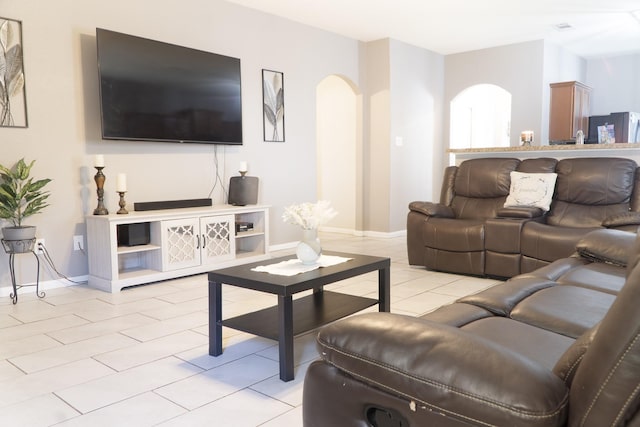 1204 Bluff View Dr, Hutchins, TX 75141 - living room with arched walkways, light tile patterned flooring, and baseboards