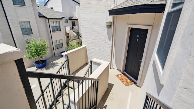 3901 Travis St Unit 230, Dallas, TX 75204 - property entrance with brick siding, a balcony, and a shingled roof