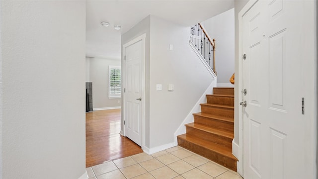 3901 Travis St Unit 230, Dallas, TX 75204 - stairway with baseboards and tile patterned flooring