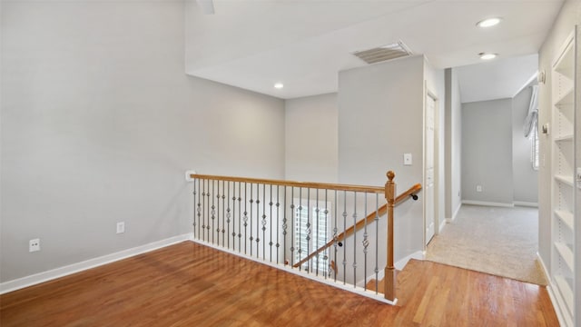 3901 Travis St Unit 230, Dallas, TX 75204 - corridor with an upstairs landing, baseboards, wood finished floors, and recessed lighting