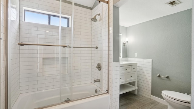 3901 Travis St Unit 230, Dallas, TX 75204 - full bath with toilet, wood finished floors, combined bath / shower with glass door, vanity, and baseboards