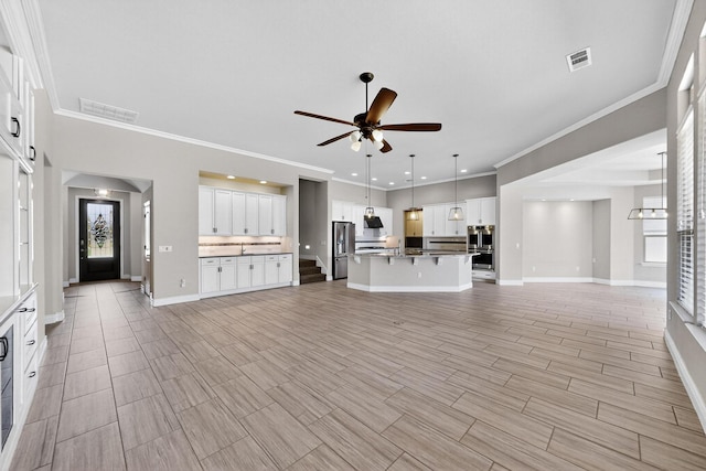 8013 American Way, Denton, TX 76207 - unfurnished living room with ceiling fan, crown molding, baseboards, recessed lighting, and plenty of natural light