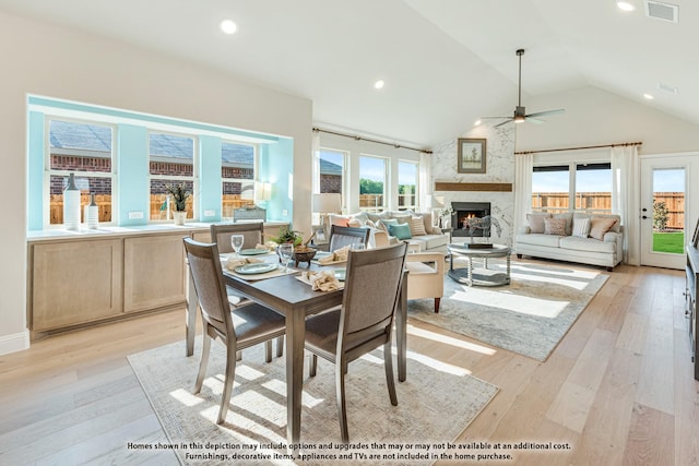 404 Atlas Cedar Dr, Glenn Heights, TX 75154 - dining space featuring ceiling fan, a high end fireplace, light wood-style flooring, recessed lighting, and high vaulted ceiling