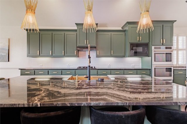 4300 Round Valley Ln, Fort Worth, TX 76262 - kitchen with green cabinetry, white double oven, black microwave, and decorative backsplash