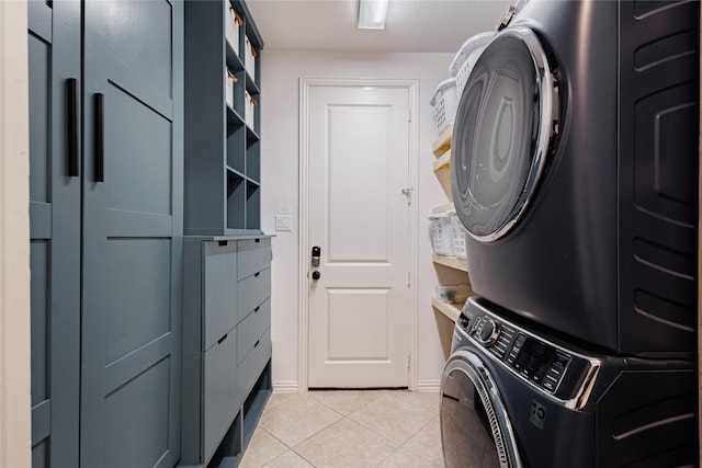 4300 Round Valley Ln, Fort Worth, TX 76262 - washroom featuring stacked washer and clothes dryer, light tile patterned floors, and baseboards