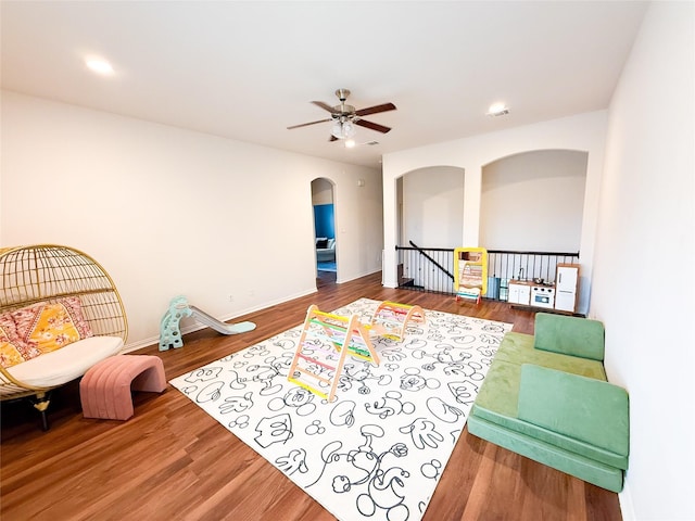 4300 Round Valley Ln, Fort Worth, TX 76262 - sitting room with arched walkways, a ceiling fan, an upstairs landing, wood finished floors, and baseboards