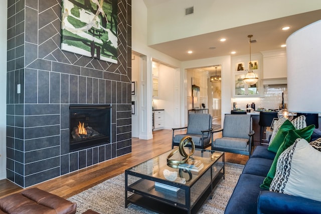 2203 Steed Run Dr, Mansfield, TX 76063 - living area featuring wood finished floors, a tile fireplace, recessed lighting, and a high ceiling