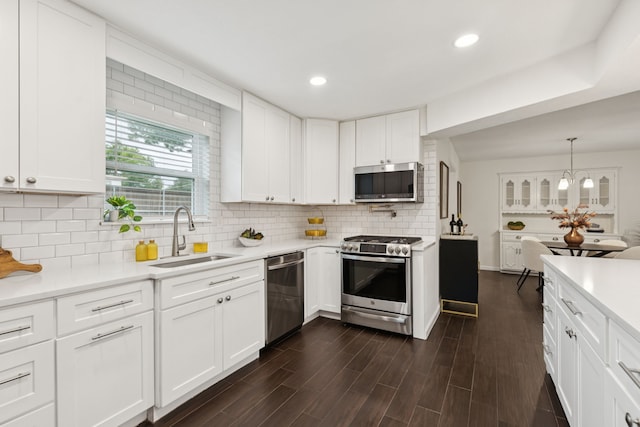 10328 Countess Dr, Dallas, TX 75229 - kitchen featuring stainless steel appliances, light countertops, white cabinetry, and recessed lighting