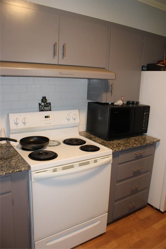 108 Mockingbird St, Mount Pleasant, TX 75455 - kitchen featuring white appliances, gray cabinetry, decorative backsplash, and light wood-style floors