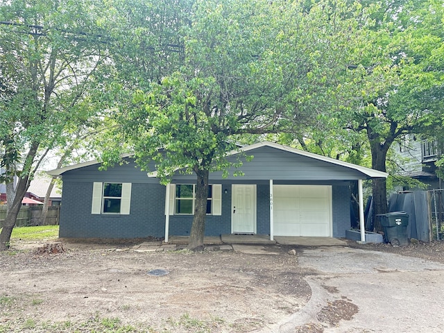 3801 Old Troup Hwy, Tyler, TX 75707 - view of front facade featuring brick siding, covered porch, an attached garage, and asphalt driveway