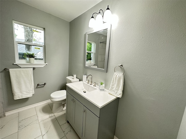 3801 Old Troup Hwy, Tyler, TX 75707 - bathroom with marble look tiles, vanity, toilet, and baseboards