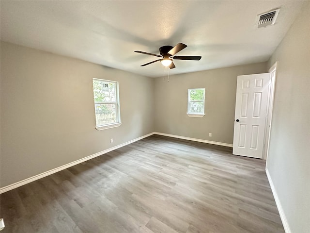 3801 Old Troup Hwy, Tyler, TX 75707 - empty room with plenty of natural light, baseboards, and wood finished floors