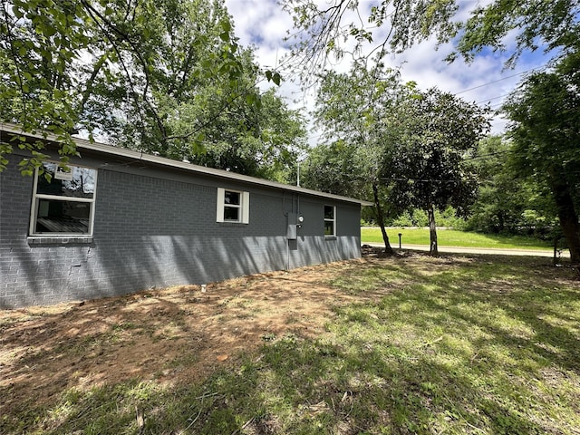3801 Old Troup Hwy, Tyler, TX 75707 - view of side of home featuring brick siding and a yard