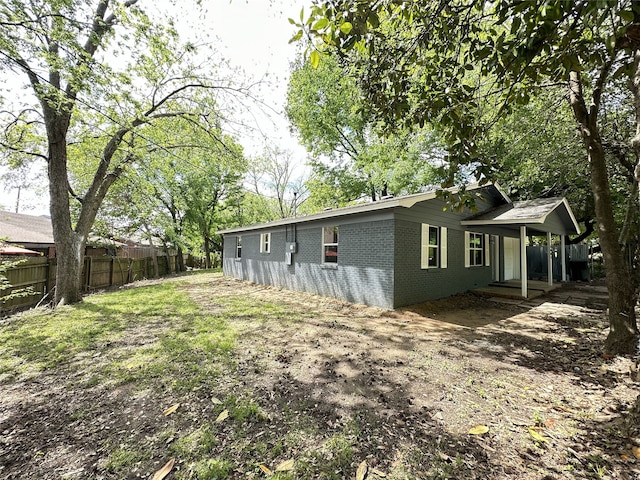 3801 Old Troup Hwy, Tyler, TX 75707 - view of side of home featuring brick siding and a porch