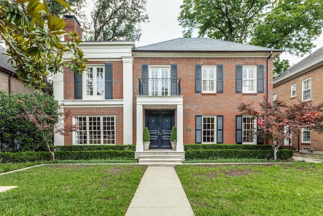4205 Bryn Mawr Dr, University Park, TX 75225 - view of front of home with a balcony, french doors, brick siding, a front yard, and a chimney