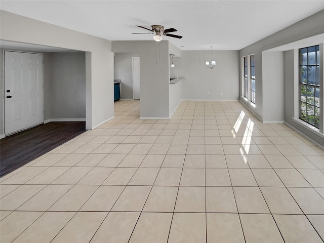 4800 Sugar Tree Ct, Arlington, TX 76017 - empty room featuring ceiling fan, light tile patterned floors, a chandelier, and baseboards