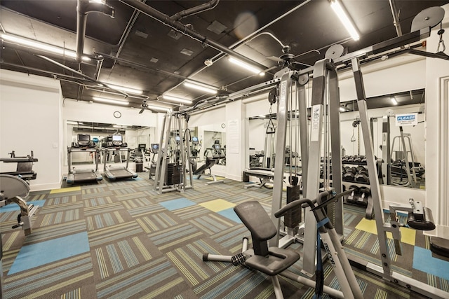 4240 Prescott Ave Unit 5B, Dallas, TX 75219 - exercise room featuring baseboards and carpet