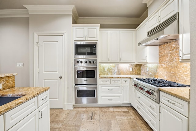 4240 Prescott Ave Unit 5B, Dallas, TX 75219 - kitchen featuring under cabinet range hood, stainless steel appliances, crown molding, tasteful backsplash, and white cabinetry