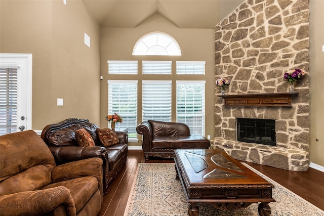 1518 E Oates Rd, Garland, TX 75043 - living room featuring hardwood / wood-style floors, a stone fireplace, and high vaulted ceiling