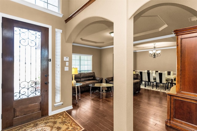 1518 E Oates Rd, Garland, TX 75043 - entryway featuring arched walkways, healthy amount of natural light, dark wood-style floors, a raised ceiling, and ornamental molding