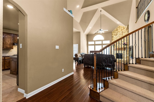 1518 E Oates Rd, Garland, TX 75043 - staircase with high vaulted ceiling, arched walkways, a ceiling fan, and hardwood / wood-style floors