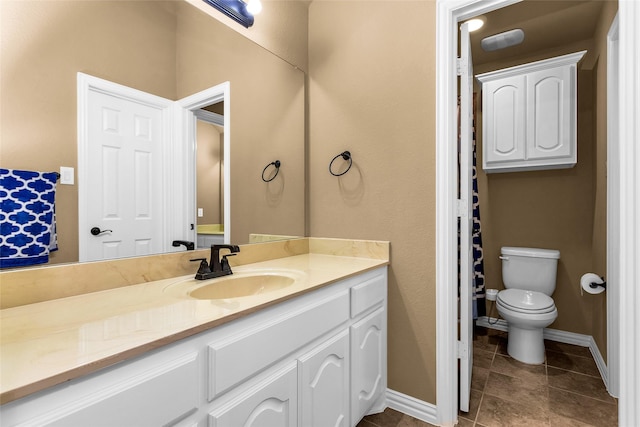 1518 E Oates Rd, Garland, TX 75043 - bathroom with vanity, baseboards, toilet, and tile patterned flooring