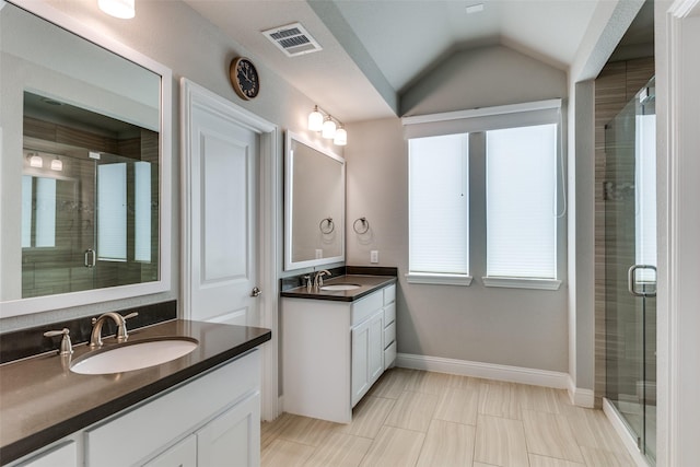 1031 Devonshire Dr, Allen, TX 75013 - bathroom featuring a stall shower, two vanities, vaulted ceiling, baseboards, and tile patterned flooring