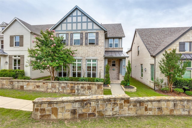 1031 Devonshire Dr, Allen, TX 75013 - view of front of home with brick siding, roof with shingles, a front yard, and a standing seam roof