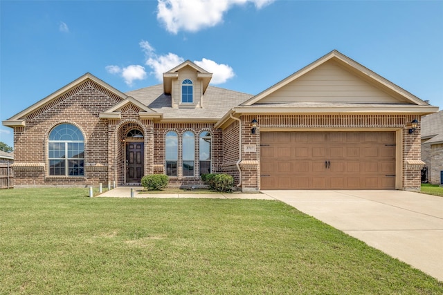 3717 Dutch Iris Ln, Forest Hill, TX 76140 - view of front of house with brick siding, a front lawn, driveway, an attached garage, and roof with shingles