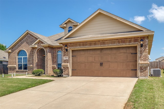 3717 Dutch Iris Ln, Forest Hill, TX 76140 - view of front of home with brick siding, an attached garage, driveway, and central air condition unit