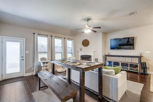 3717 Dutch Iris Ln, Forest Hill, TX 76140 - living room with a glass covered fireplace, dark wood-type flooring, ceiling fan, and baseboards