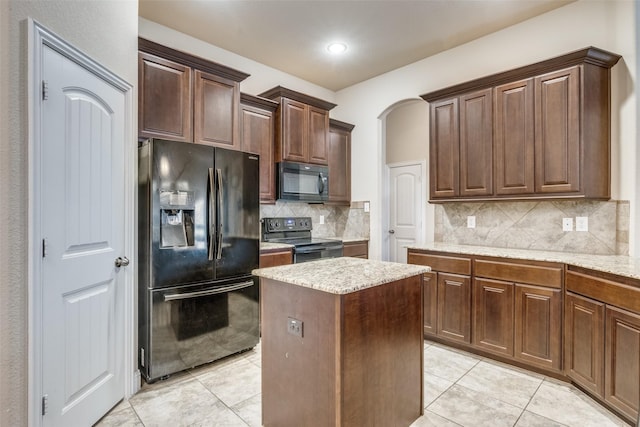 3717 Dutch Iris Ln, Forest Hill, TX 76140 - kitchen featuring black appliances, light tile patterned flooring, a kitchen island, backsplash, and light stone countertops
