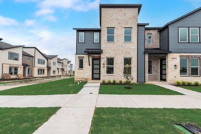 8901 Lowell St, Rowlett, TX 75089 - view of property featuring a residential view, a front lawn, a standing seam roof, brick siding, and stone siding